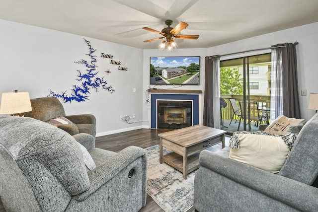 123 Bunker Ridge Dr Unit 7, Branson, MO 65616 - living area featuring wood finished floors, ceiling fan, and a glass covered fireplace