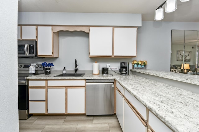 123 Bunker Ridge Dr Unit 7, Branson, MO 65616 - kitchen featuring appliances with stainless steel finishes, light countertops, and white cabinetry