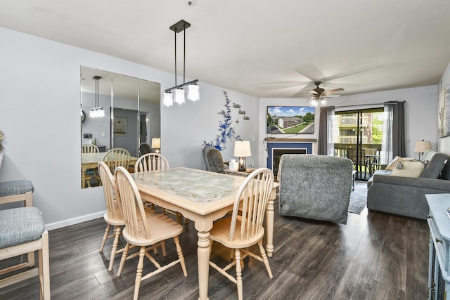 123 Bunker Ridge Dr Unit 7, Branson, MO 65616 - dining area with ceiling fan, dark wood-type flooring, and a fireplace