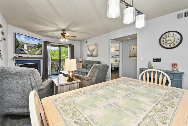 123 Bunker Ridge Dr Unit 7, Branson, MO 65616 - dining room with wood finished floors, ceiling fan, and a fireplace