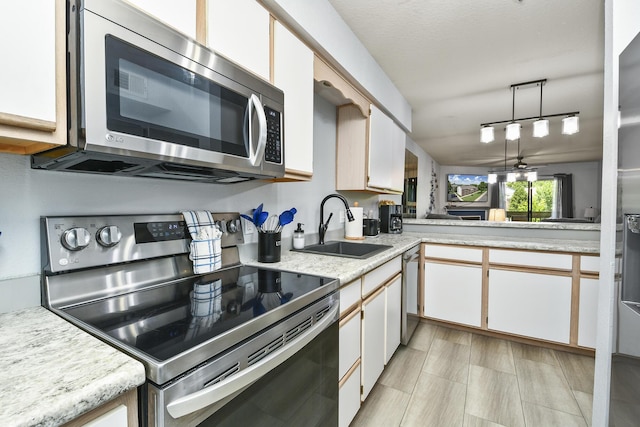 123 Bunker Ridge Dr Unit 7, Branson, MO 65616 - kitchen with appliances with stainless steel finishes, light countertops, and white cabinets