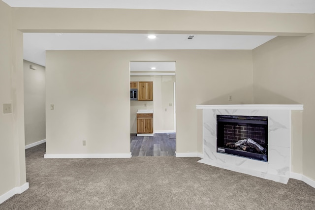 707 N College Ave, Republic, MO 65738 - unfurnished living room featuring carpet floors, a fireplace, and recessed lighting