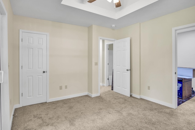 707 N College Ave, Republic, MO 65738 - unfurnished bedroom featuring carpet, a ceiling fan, and a raised ceiling