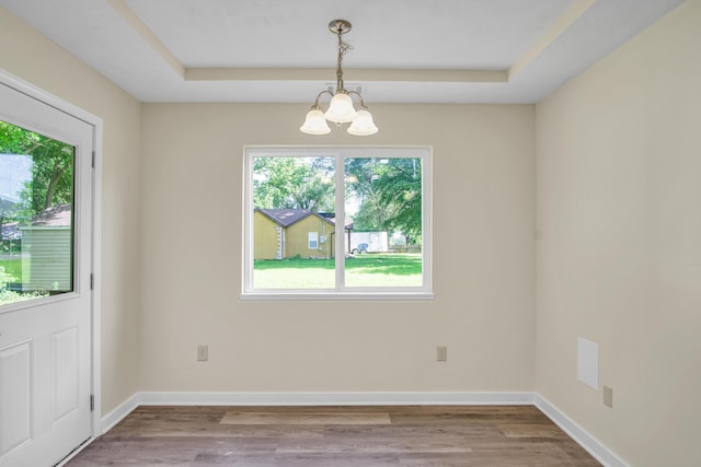 707 N College Ave, Republic, MO 65738 - unfurnished dining area with a chandelier, wood finished floors, and a raised ceiling
