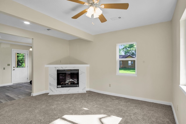 707 N College Ave, Republic, MO 65738 - unfurnished living room with carpet floors, plenty of natural light, a premium fireplace, and ceiling fan