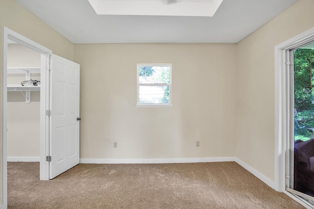 707 N College Ave, Republic, MO 65738 - unfurnished bedroom featuring carpet, a skylight, and a spacious closet