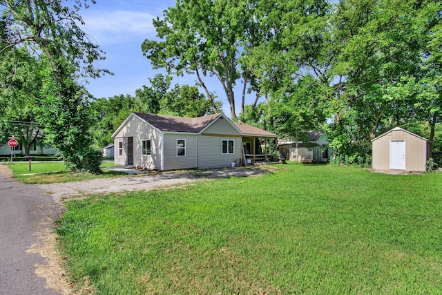 707 N College Ave, Republic, MO 65738 - rear view of house featuring a storage unit, a lawn, and asphalt driveway