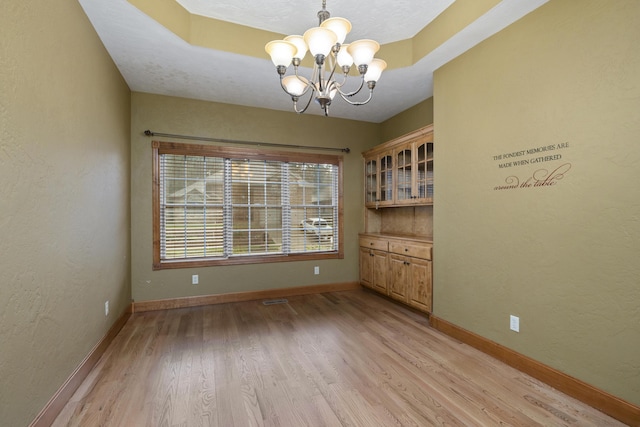 1225 W Wildcherry St, Ozark, MO 65721 - unfurnished dining area featuring a chandelier and light wood-type flooring
