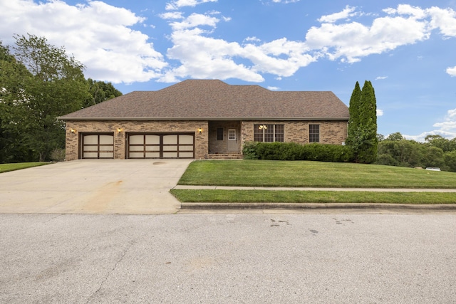 1225 W Wildcherry St, Ozark, MO 65721 - view of front of house with a front yard, a garage, driveway, and brick siding