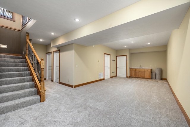 1225 W Wildcherry St, Ozark, MO 65721 - below grade area featuring light carpet, stairs, and recessed lighting