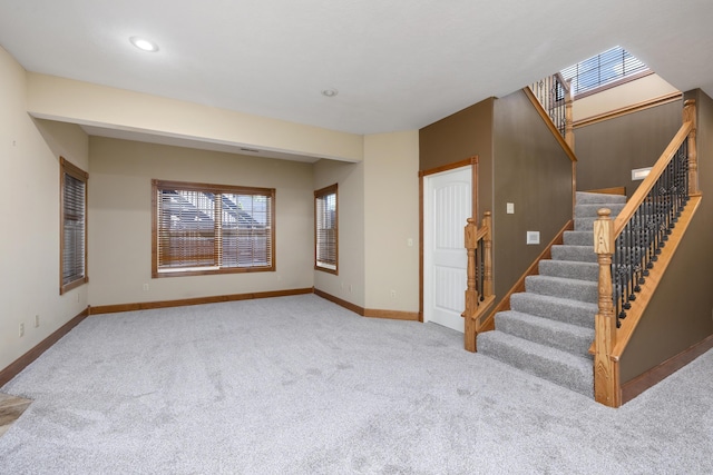 1225 W Wildcherry St, Ozark, MO 65721 - unfurnished living room with carpet flooring, stairs, and recessed lighting