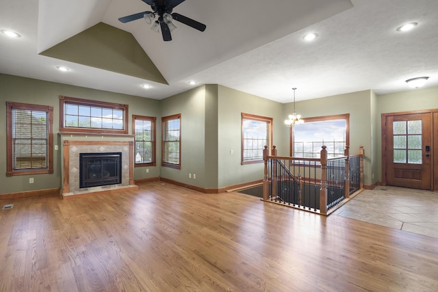 1225 W Wildcherry St, Ozark, MO 65721 - unfurnished living room with ceiling fan, healthy amount of natural light, recessed lighting, lofted ceiling, and a tiled fireplace
