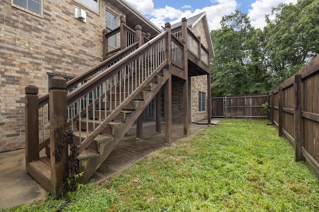 1225 W Wildcherry St, Ozark, MO 65721 - back of house featuring a fenced backyard, brick siding, stairs, a wooden deck, and cooling unit