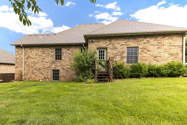 1225 W Wildcherry St, Ozark, MO 65721 - back of house featuring a yard, brick siding, and a shingled roof