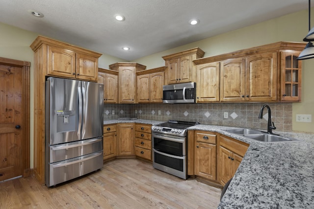 1225 W Wildcherry St, Ozark, MO 65721 - kitchen featuring stainless steel appliances, light wood-type flooring, light stone counters, tasteful backsplash, and recessed lighting