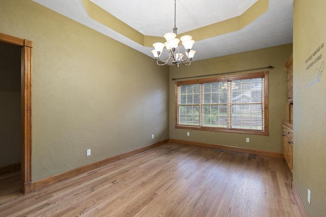 1225 W Wildcherry St, Ozark, MO 65721 - empty room featuring light wood-style floors and a chandelier