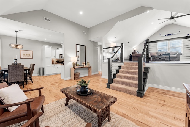 811 Gold Rush Ave, Nixa, MO 65714 - living room with lofted ceiling, light wood-style floors, stairway, healthy amount of natural light, and ceiling fan