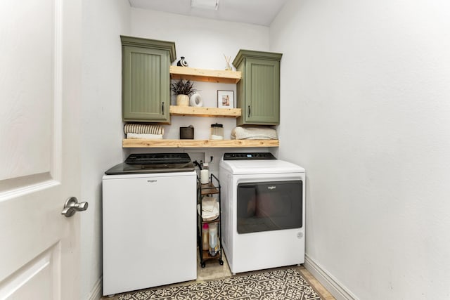 811 Gold Rush Ave, Nixa, MO 65714 - laundry area featuring washer and dryer and cabinet space