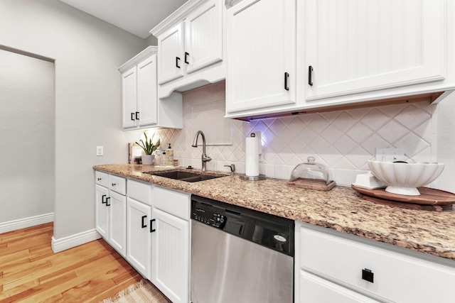 811 Gold Rush Ave, Nixa, MO 65714 - kitchen with dishwasher, decorative backsplash, light wood-style floors, white cabinetry, and light stone countertops
