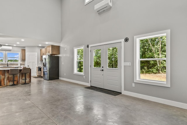 3918 Bowen Creek Rd, Niangua, MO 65713 - entrance foyer featuring a wall mounted air conditioner, concrete flooring, a high ceiling, and a wall mounted AC