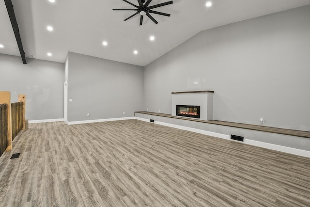 3918 Bowen Creek Rd, Niangua, MO 65713 - unfurnished living room featuring ceiling fan, recessed lighting, wood finished floors, a glass covered fireplace, and lofted ceiling