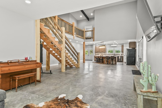 3918 Bowen Creek Rd, Niangua, MO 65713 - living room with finished concrete floors, recessed lighting, stairway, and a towering ceiling