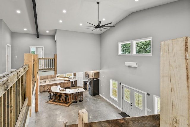 3918 Bowen Creek Rd, Niangua, MO 65713 - living room with high vaulted ceiling, concrete floors, a ceiling fan, recessed lighting, and french doors
