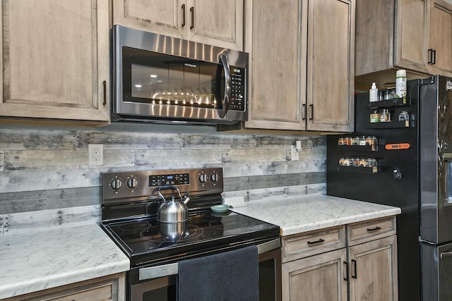 3918 Bowen Creek Rd, Niangua, MO 65713 - kitchen featuring stainless steel microwave, range with electric stovetop, and freestanding refrigerator