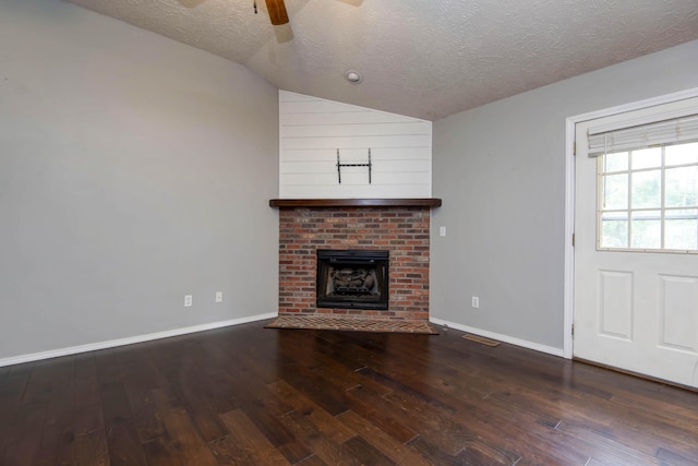 4252 W Madison St, Springfield, MO 65802 - unfurnished living room featuring a textured ceiling, vaulted ceiling, wood finished floors, a ceiling fan, and a fireplace