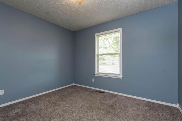 4252 W Madison St, Springfield, MO 65802 - empty room featuring carpet and a textured ceiling