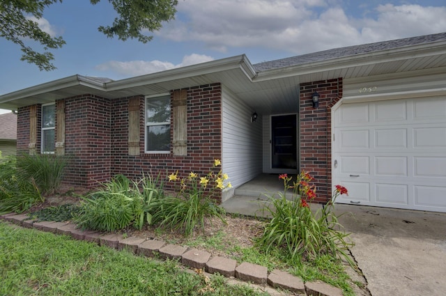 4252 W Madison St, Springfield, MO 65802 - view of front facade featuring an attached garage and brick siding