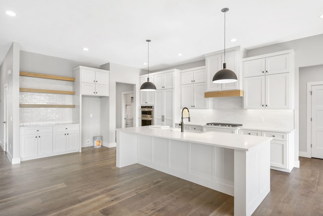 1632 Marlowe Ave, Springfield, MO 65802 - kitchen with stainless steel double oven, gas stovetop, decorative backsplash, white cabinets, and light countertops