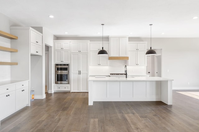 1632 Marlowe Ave, Springfield, MO 65802 - kitchen with stainless steel double oven, open shelves, white cabinets, light countertops, and wood finished floors