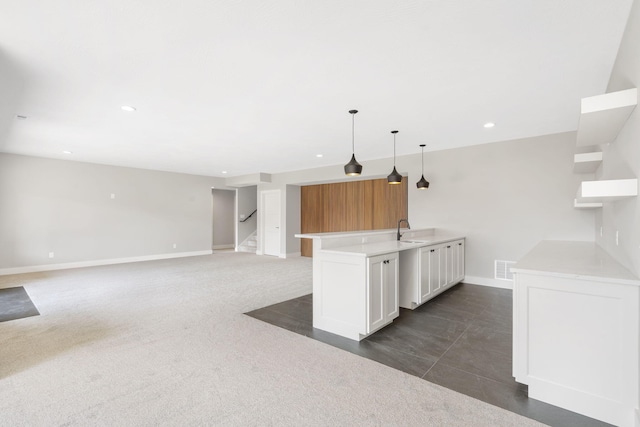1632 Marlowe Ave, Springfield, MO 65802 - kitchen with light countertops, recessed lighting, white cabinets, hanging light fixtures, and a peninsula