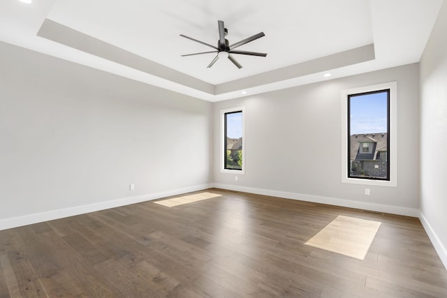 1632 Marlowe Ave, Springfield, MO 65802 - spare room with a tray ceiling, plenty of natural light, a ceiling fan, dark wood-type flooring, and recessed lighting
