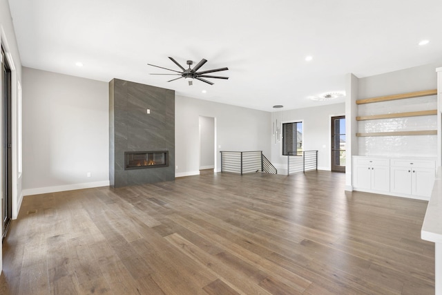 1632 Marlowe Ave, Springfield, MO 65802 - unfurnished living room featuring ceiling fan, wood finished floors, recessed lighting, and a fireplace