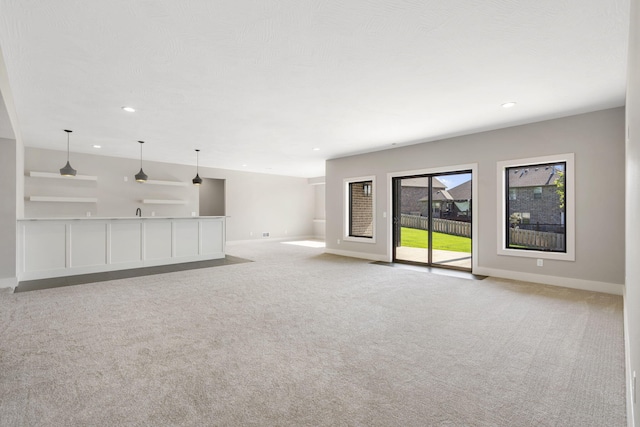 1632 Marlowe Ave, Springfield, MO 65802 - unfurnished living room featuring light colored carpet and recessed lighting