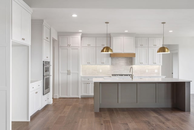 1650 Marlowe Ave, Springfield, MO 65802 - kitchen with light countertops, wood finished floors, appliances with stainless steel finishes, backsplash, and recessed lighting