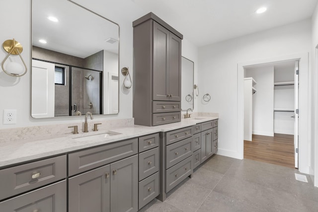1650 Marlowe Ave, Springfield, MO 65802 - bathroom featuring a shower stall, double vanity, recessed lighting, and a spacious closet