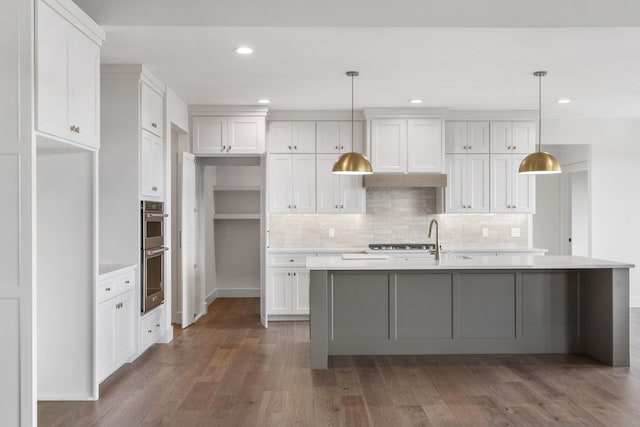 1650 Marlowe Ave, Springfield, MO 65802 - kitchen with stainless steel appliances, white cabinets, light countertops, decorative backsplash, and dark wood-type flooring