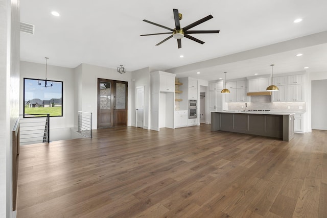 1650 Marlowe Ave, Springfield, MO 65802 - unfurnished living room featuring dark wood finished floors, ceiling fan, and recessed lighting