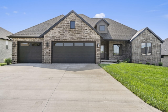1650 Marlowe Ave, Springfield, MO 65802 - view of front of home with concrete driveway, brick siding, a garage, a front lawn, and roof with shingles
