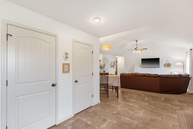1300 W Robin St, Ozark, MO 65721 - living room featuring a ceiling fan, lofted ceiling, and light stone finish floors
