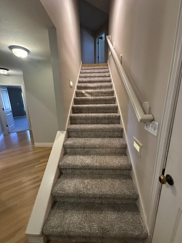 5605 N Seacrest Dr, Ozark, MO 65721 - stairs featuring wood finished floors and baseboards