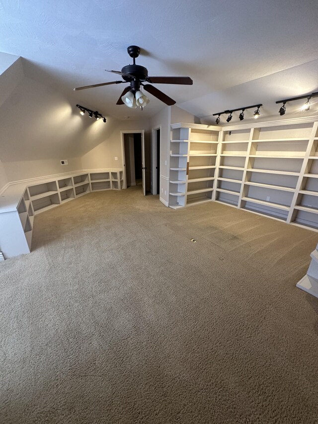 5605 N Seacrest Dr, Ozark, MO 65721 - unfurnished living room featuring track lighting, ceiling fan, carpet floors, and vaulted ceiling