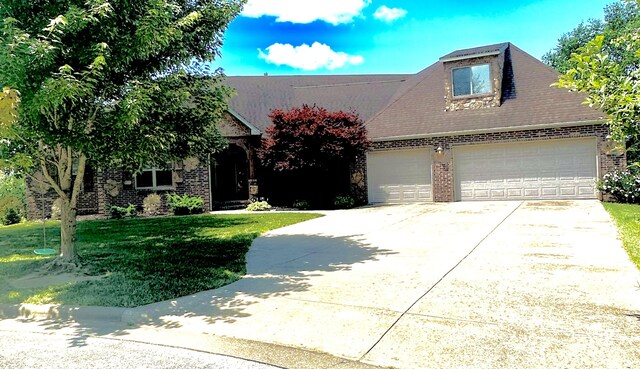5605 N Seacrest Dr, Ozark, MO 65721 - view of front of property with brick siding, concrete driveway, a front yard, and an attached garage