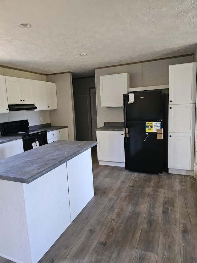 000 Oak St, Conway, MO 65632 - kitchen with black appliances, under cabinet range hood, dark countertops, white cabinets, and a textured ceiling