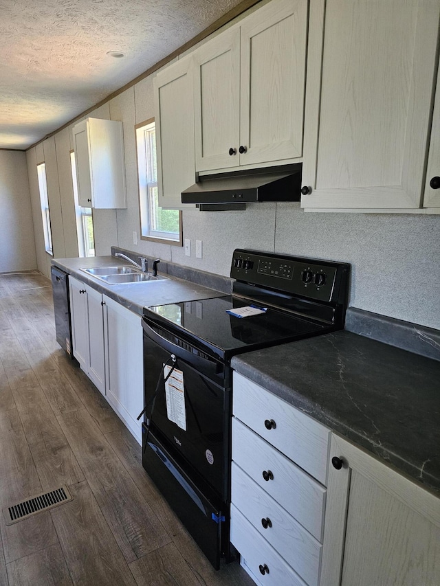 000 Oak St, Conway, MO 65632 - kitchen featuring black electric range oven, dark wood-style floors, under cabinet range hood, a textured ceiling, and dishwashing machine