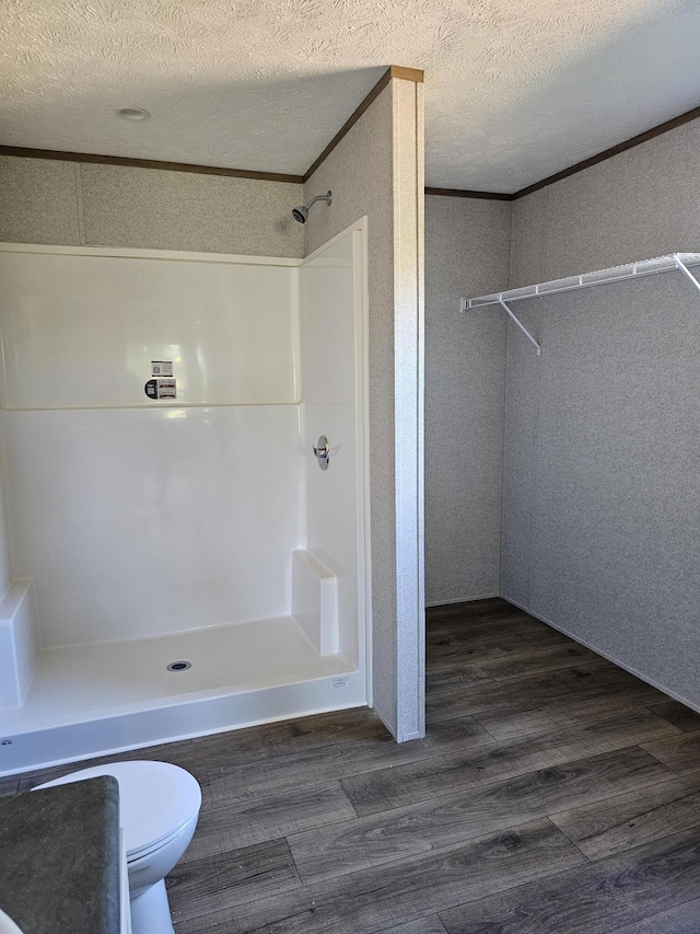 000 Oak St, Conway, MO 65632 - bathroom featuring walk in shower, wood finished floors, and a textured ceiling