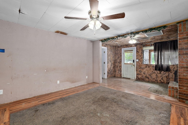 427 Morgan Ave, Aurora, MO 65605 - spare room featuring wood finished floors and a ceiling fan
